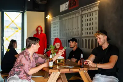 a group of men sitting at a table in a restaurant at Whoopers Hostel Ao Nang - By The Beach in Ban Khlong Haeng