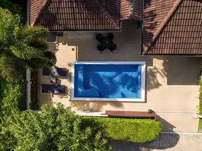 an overhead view of a swimming pool on the side of a house at Villa Vie Phuket Rawai 3 Bedrooms in Ban Saiyuan (1)