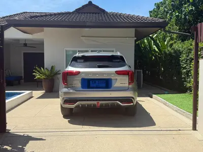 a white car parked in front of a house at Villa Vie Phuket Rawai 3 Bedrooms in Ban Saiyuan (1)