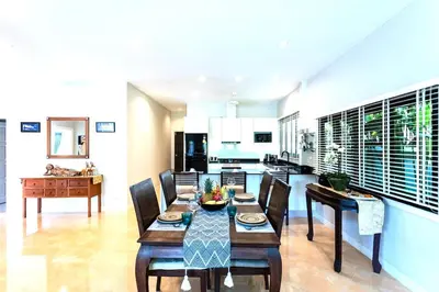a kitchen and dining room with a table and chairs at Villa Vie Phuket Rawai 3 Bedrooms in Ban Saiyuan (1)