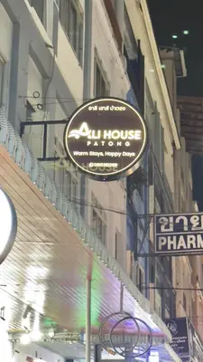 a sign for an all house restaurant on a building at Ali House Patong in Patong Beach