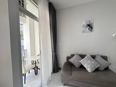 a living room with a couch and a table at Ali House Patong in Patong Beach