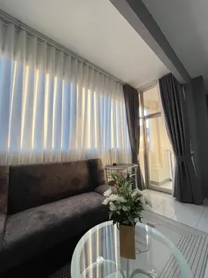 a living room with a couch and a glass table at Ali House Patong in Patong Beach