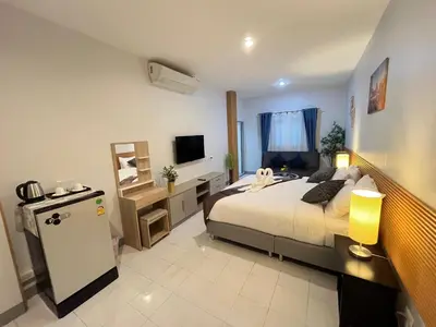 a bedroom with a bed and a television in it at Ali House Patong in Patong Beach