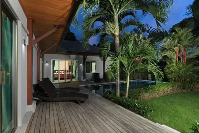 a house with a wooden deck and a swimming pool at VILLA HENI Private pool 3BR villaNaiharn beach in Nai Harn Beach