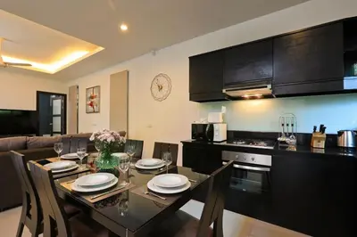 a kitchen and dining room with a table and chairs at VILLA HENI Private pool 3BR villaNaiharn beach in Nai Harn Beach