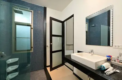 a bathroom with a sink and a mirror and a shower at VILLA HENI Private pool 3BR villaNaiharn beach in Nai Harn Beach