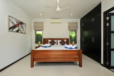 a bedroom with a bed in a room at VILLA HENI Private pool 3BR villaNaiharn beach in Nai Harn Beach