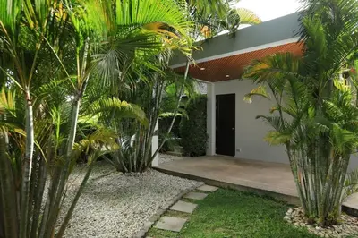 a house with palm trees in front of it at VILLA HENI Private pool 3BR villaNaiharn beach in Nai Harn Beach