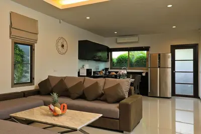a living room with a couch and a kitchen at VILLA HENI Private pool 3BR villaNaiharn beach in Nai Harn Beach