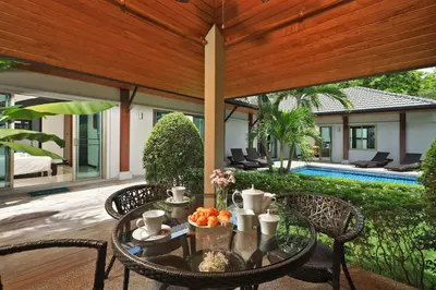 a table with a bowl of fruit on a patio at VILLA HENI Private pool 3BR villaNaiharn beach in Nai Harn Beach