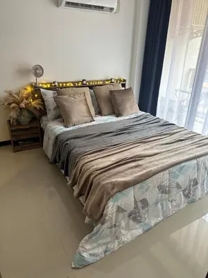 a large bed in a room with a window at Комфортные апартаменты Пхукет NBC in Rawai Beach