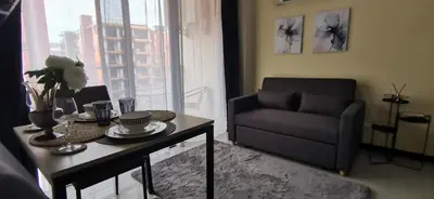 a living room with a coffee table and a couch at Комфортные апартаменты Пхукет NBC in Rawai Beach