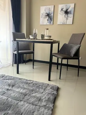 a dining table and chairs in a living room at Комфортные апартаменты Пхукет NBC in Rawai Beach