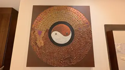a painting hanging on a wall in a room at Baan Phu Chalong Place in Ban Suan