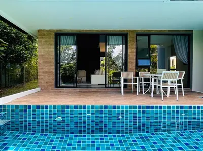 a house with a swimming pool with a table and chairs at Tierra Utopia