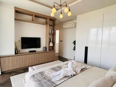 a bedroom with a large bed and a flat screen tv at Tierra Utopia