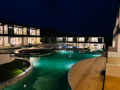 a swimming pool in a building at night at Tierra Utopia