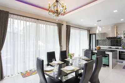 a dining room and kitchen with a table and chairs at Kathu V pool villa 170 in Kathu