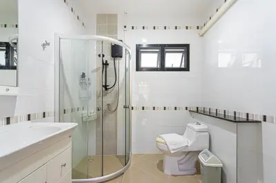a bathroom with a shower and a toilet and a sink at Kathu V pool villa 170 in Kathu