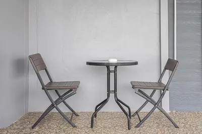 two chairs and a table and a table and two chairs at Kathu V pool villa 170 in Kathu
