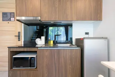 a kitchen with a sink and a microwave at Stylish Loft at Utopia Nai Harn great amenities in Rawai Beach