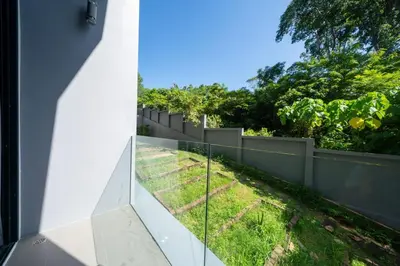 a view from the side of a house with a fence at Stylish Loft at Utopia Nai Harn great amenities in Rawai Beach