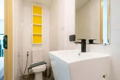 a white bathroom with a sink and a toilet at Stylish Loft at Utopia Nai Harn great amenities in Rawai Beach