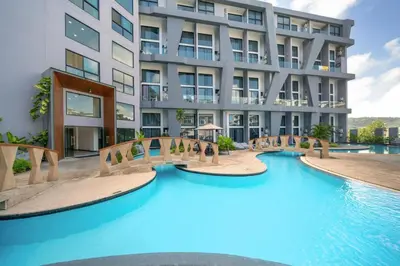 a swimming pool in front of a building at Stylish Loft at Utopia Nai Harn great amenities in Rawai Beach
