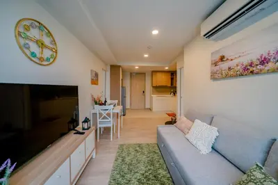 a living room with a couch and a tv at Sky park 2 bedroom 60m2 in Laguna Phuket