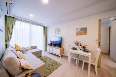 a living room with a couch and a table at Sky park 2 bedroom 60m2 in Laguna Phuket