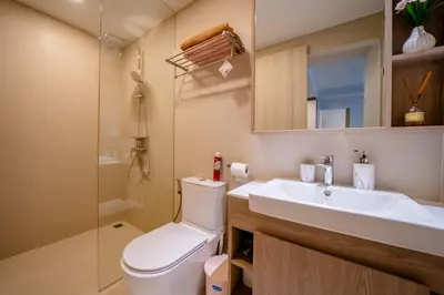 a bathroom with a toilet and a sink and a shower at Sky park 2 bedroom 60m2 in Laguna Phuket