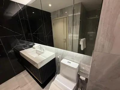 a bathroom with a toilet and a sink and a mirror at Bellevue lagoon 2 bedrooms in Laguna Phuket