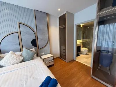 a bedroom with a bed and a large mirror at Bellevue lagoon 2 bedrooms in Laguna Phuket