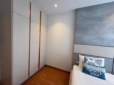 a bedroom with a bed and a painting on the wall at Bellevue lagoon 2 bedrooms in Laguna Phuket
