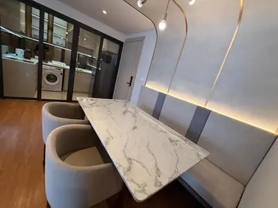 a marble table and chairs in a room at Bellevue lagoon 2 bedrooms in Laguna Phuket