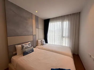 a bedroom with two beds and a window at Bellevue lagoon 2 bedrooms in Laguna Phuket