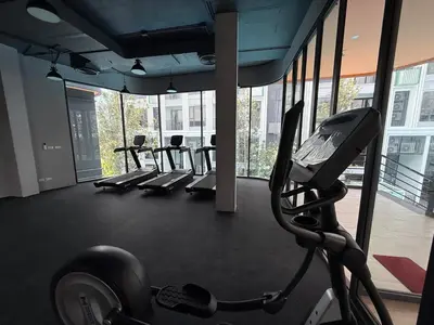 a gym with a row of treadmills and a treadmill at Bellevue Bangtao 2 bedrooms in Laguna Phuket