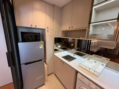 a kitchen with a refrigerator and a sink at Bellevue Bangtao 2 bedrooms in Laguna Phuket