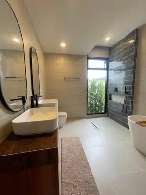a bathroom with a sink and a toilet and a mirror at Ozone vista Rawai in Ban Saiyuan (1)