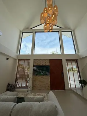 a living room with a couch and a large window at Ozone vista Rawai in Ban Saiyuan (1)