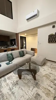a living room with a couch and a table at Ozone vista Rawai in Ban Saiyuan (1)