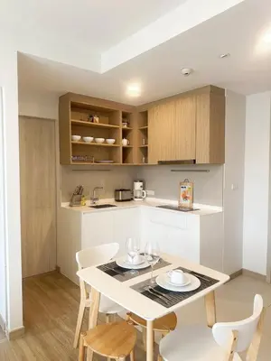 a kitchen and dining room with a table and chairs at Bangtao Rooftop Seaview Laguna Skypark Condominium in Bang Tao Beach