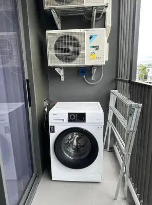 a washing machine in a room with a fan at Bangtao Rooftop Seaview Laguna Skypark Condominium in Bang Tao Beach