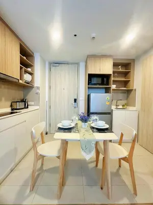 a dining room with a table and chairs in a kitchen at Bangtao Rooftop Seaview Laguna Skypark Condominium in Bang Tao Beach