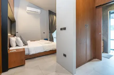a bedroom with a bed with white sheets and a window at Sparrow Villa - Kamala Beach in Kamala Beach