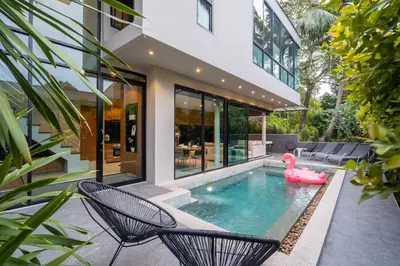 a swimming pool in a house with a pink swan in the water at Sparrow Villa - Kamala Beach in Kamala Beach