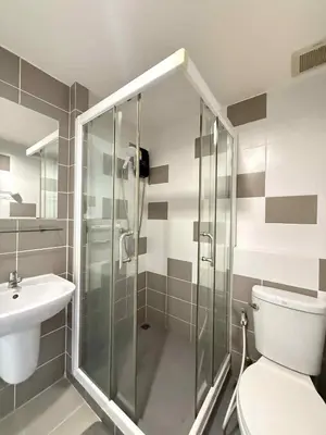 a bathroom with a shower and a toilet and a sink at Zcape garden view Phuket in Ban Rangeng