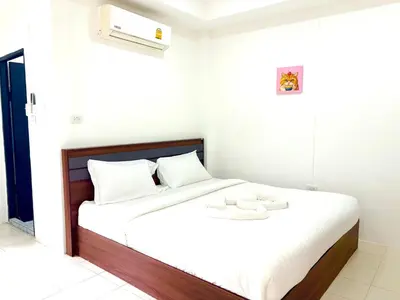 a bedroom with a bed with white sheets and white pillows at Patong Canal Villa 109 in Patong Beach