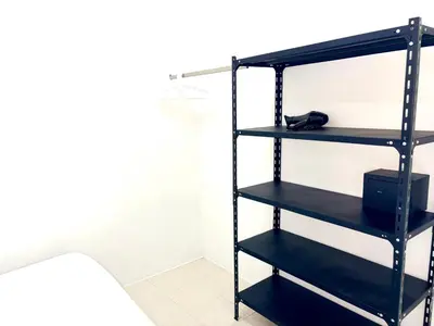a black book shelf with a phone on it at Patong Canal Villa 109 in Patong Beach